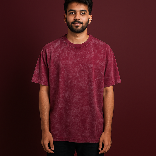 Model wearing an oversized acid wash t-shirt in brownish-red against a dark background.