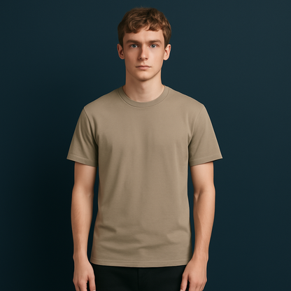 Plain drop shoulder t-shirt in beige, made from premium cotton lycra, model standing against a dark blue background.